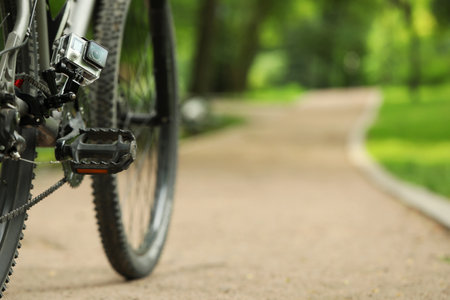 Modern action camera with mount on bicycle outdoors. Space for textの写真素材