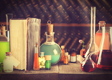 Chemist's workplace with old book and laboratory glassware, vintage styleの写真素材