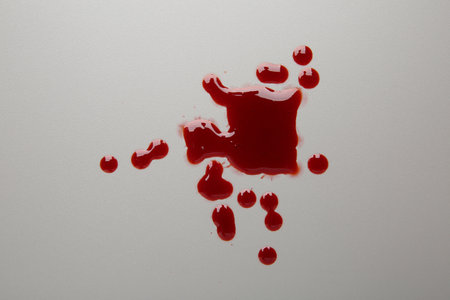 Drops of red blood on light backgroundの写真素材