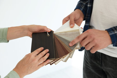 People choosing samples of wooden flooring indoors, closeupの写真素材