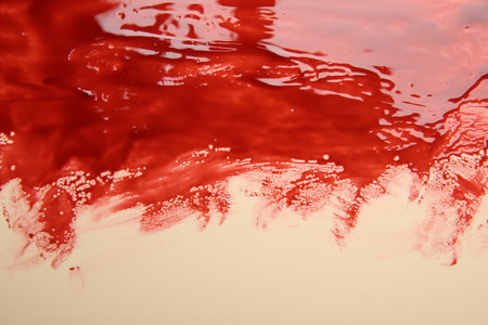 Stain of blood on beige background, closeupの写真素材