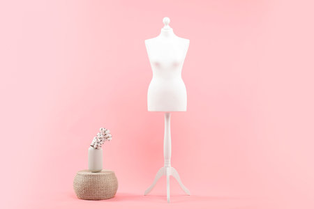 Mannequin and stylish vase on pink backgroundの写真素材