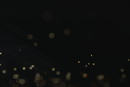 Beautiful shiny golden glitter on black background, closeupの写真素材