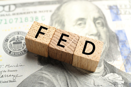 Wooden cubes with letters Fed (Federal Reserve System) on dollar banknote, closeup