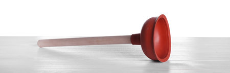 Plunger with wooden handle on white table. Pipe cleaning toolの写真素材