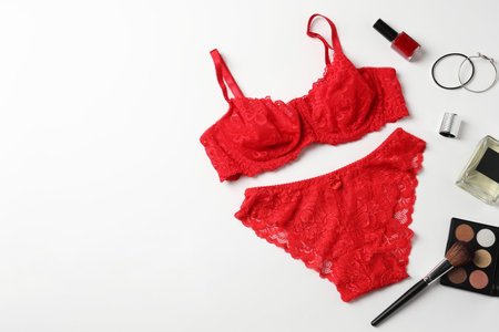 Beautiful lace lingerie and accessories on white background, flat lay. Space for textの写真素材