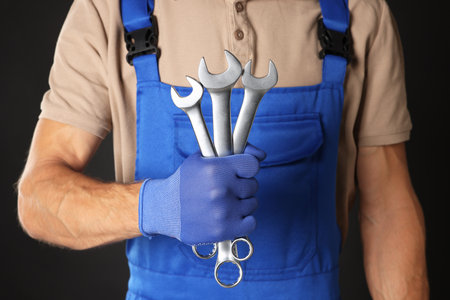 Auto mechanic with wrenches on black background, closeupの写真素材