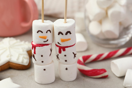 Funny snowmen made of marshmallows and other sweets on light table, closeupの写真素材