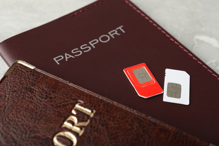 Passports and SIM cards on gray table, closeupの写真素材