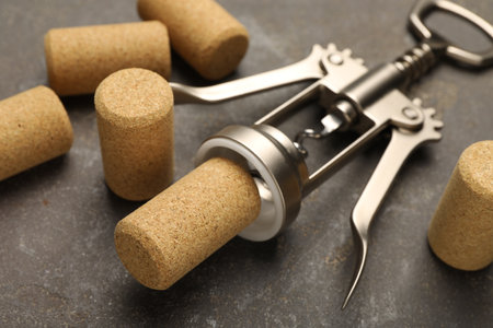 Wing corkscrew and corks on gray table, closeupの写真素材