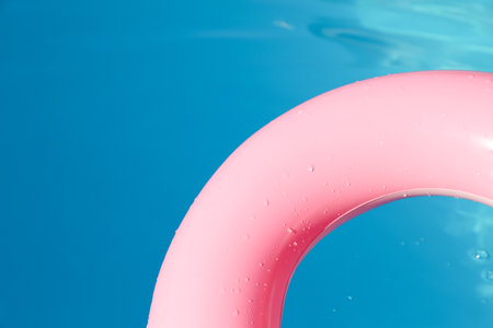 Pink inflatable ring in swimming pool outdoors, closeupの写真素材