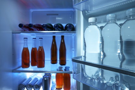 Many different cold drinks in the refrigerator, closeup