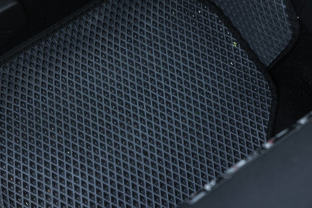 Gray rubber car floor mat in auto, top viewの写真素材