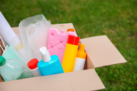 Recycling. Different garbage in cardboard box outdoorsの写真素材