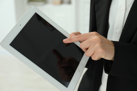 Businesswoman using tablet indoors, closeup. Modern technologyの写真素材