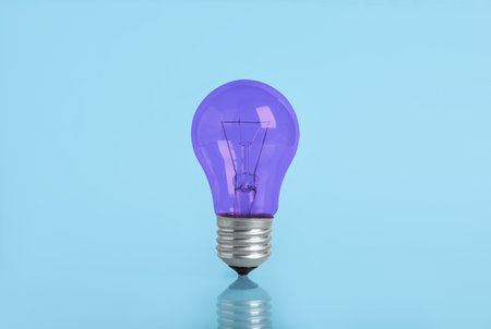 One purple bulb on light blue backgroundの写真素材