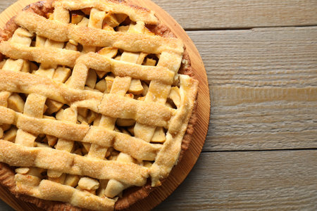 Tasty homemade apple pie on wooden table, top view. Space for textの写真素材