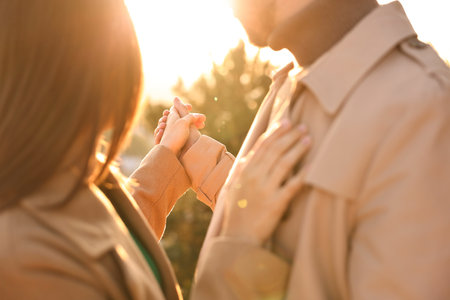 Beautiful couple dancing outdoors on sunset, closeupの写真素材