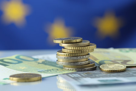 Coins and euro banknotes on table, closeupの写真素材