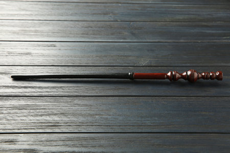 One old magic wand on wooden table
