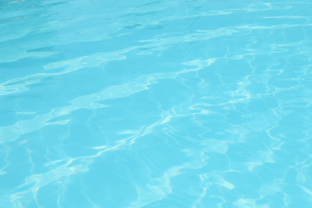 Clear water in outdoor swimming pool on sunny dayの写真素材