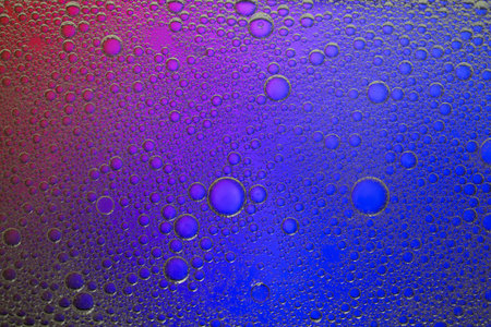 Essential oil bubbles on color background, macro view. Cosmetic product