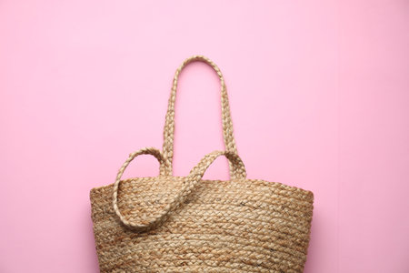 Elegant woman's straw bag on pink background, top viewの写真素材
