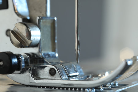 Sewing machine on light gray background, macro view