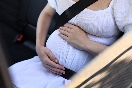 Pregnant woman with safety belt in car, closeupの写真素材