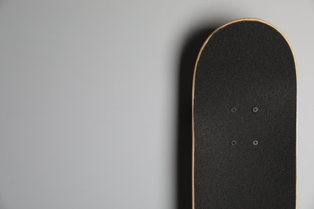 Modern skateboard on light gray background. Space for textの写真素材