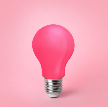 One pink light bulb on pink backgroundの写真素材