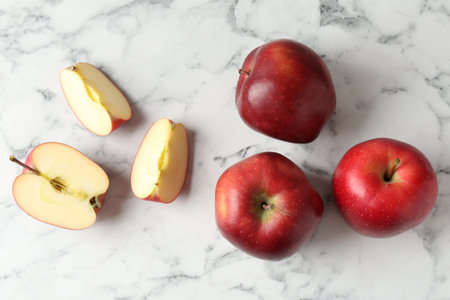 Ripe red apples on white marble table, top viewの写真素材