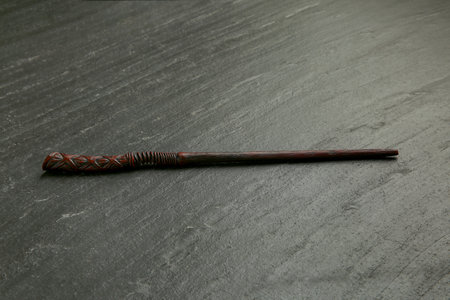 One old magic wand on black tableの写真素材