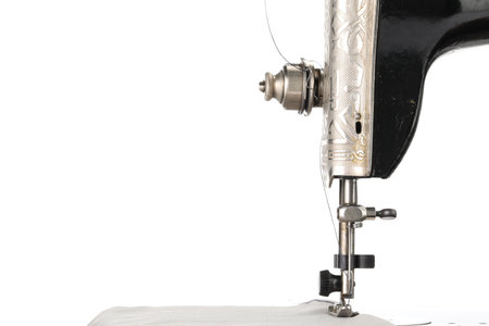 Sewing machine with gray fabric isolated on white