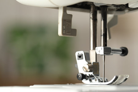 Sewing machine on blurred background, macro view. Space for textの写真素材