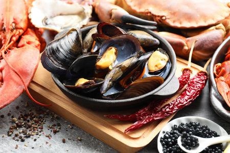 Many different sea food on gray table, closeup