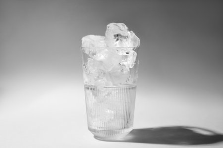 Refreshing water with ice in glass on gray backgroundの写真素材