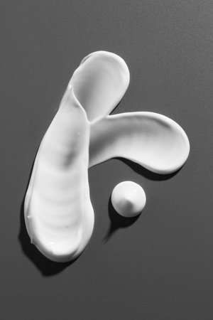 Smears of cosmetic products on gray background, top viewの写真素材