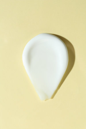 Smear of cosmetic product on beige background, top view