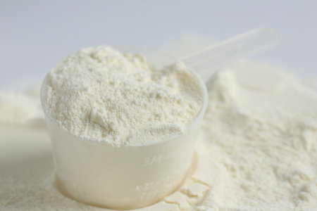 Protein powder and scoop on white background, closeupの写真素材