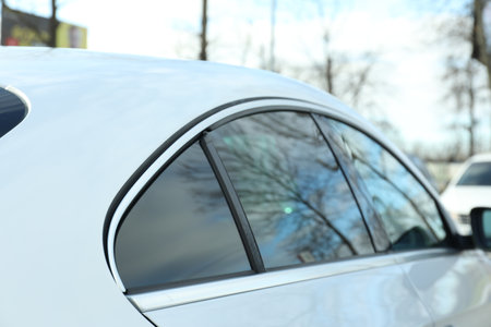 Modern car with tinting foil on window outdoors, closeupの写真素材