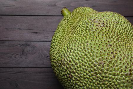Fresh exotic jackfruit on black wooden table, above view. Space for textの写真素材