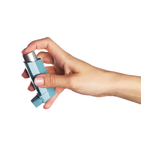 Woman holding asthma inhaler on white background, closeupの写真素材