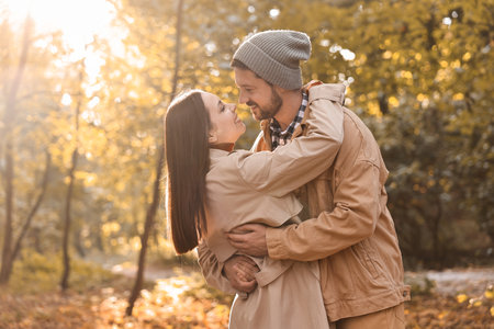 Beautiful couple spending time in park on autumn dayの写真素材