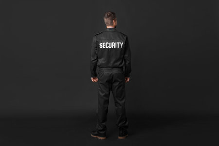 Security guard in uniform on black background, back viewの写真素材