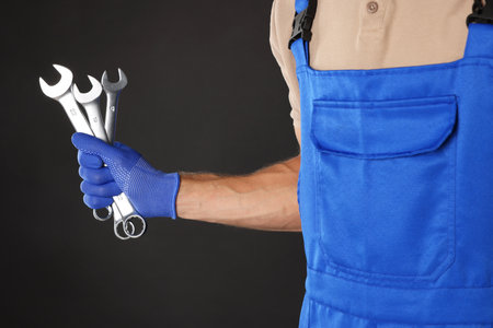 Auto mechanic with wrenches on black background, closeupの写真素材