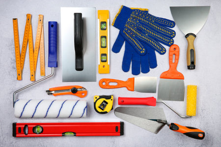 Flat lay composition with different construction tools on gray textured table
