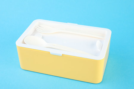 Plastic lunch box with cutlery on light blue background, closeupの写真素材