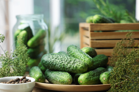 Fresh cucumbers, dill and peppercorns on table, closeup. Preparation for picklingの写真素材