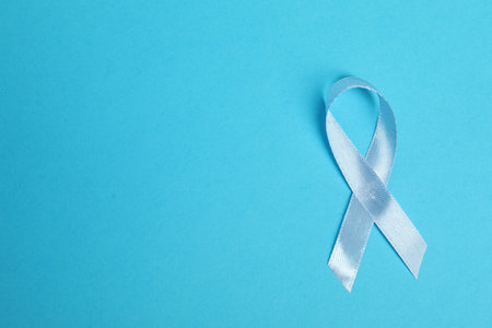 Light blue ribbon on color background, top view with space for text. Prostate cancer awarenessの写真素材